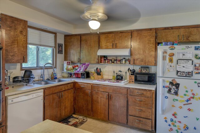 6208 N Wiscomb St, Spokane, WA 99208 - kitchen with white appliances, extractor fan, light countertops, brown cabinetry, and a ceiling fan
