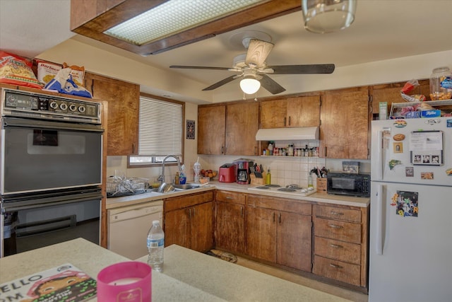 6208 N Wiscomb St, Spokane, WA 99208 - kitchen with black appliances, under cabinet range hood, light countertops, brown cabinets, and a ceiling fan