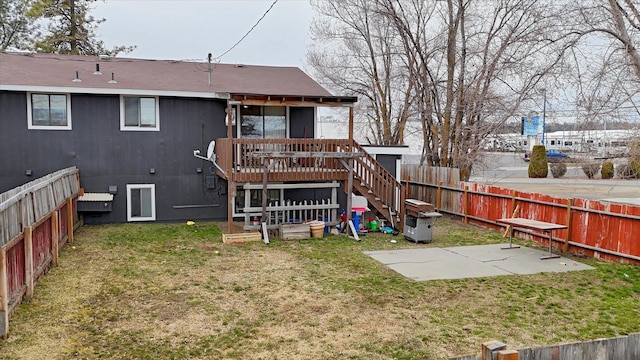 6208 N Wiscomb St, Spokane, WA 99208 - back of property with stairway, a fenced backyard, a deck, and a patio area