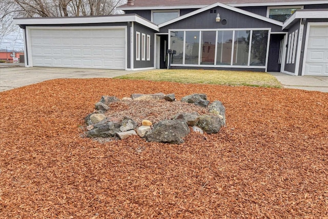 6208 N Wiscomb St, Spokane, WA 99208 - view of front of house featuring driveway and a garage