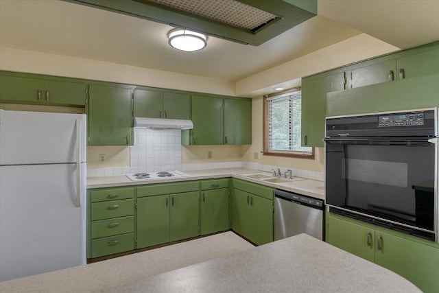 6208 N Wiscomb St, Spokane, WA 99208 - kitchen featuring white appliances, light countertops, under cabinet range hood, tasteful backsplash, and green cabinets