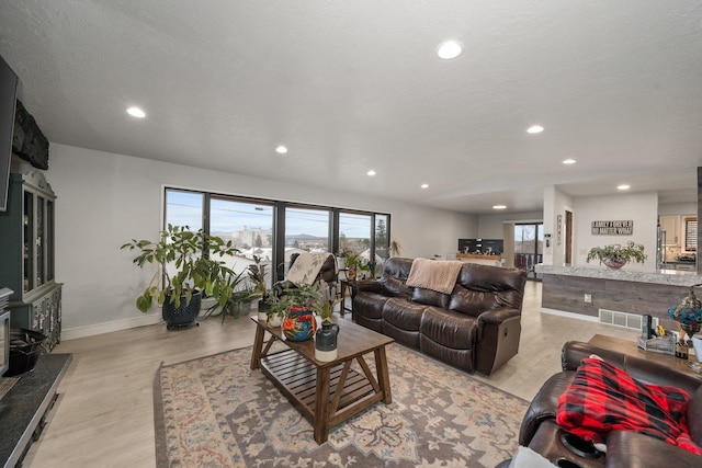 313 SE Trinity Ave, Wilbur, WA 99185 - living area with recessed lighting, plenty of natural light, light wood-style floors, and baseboards