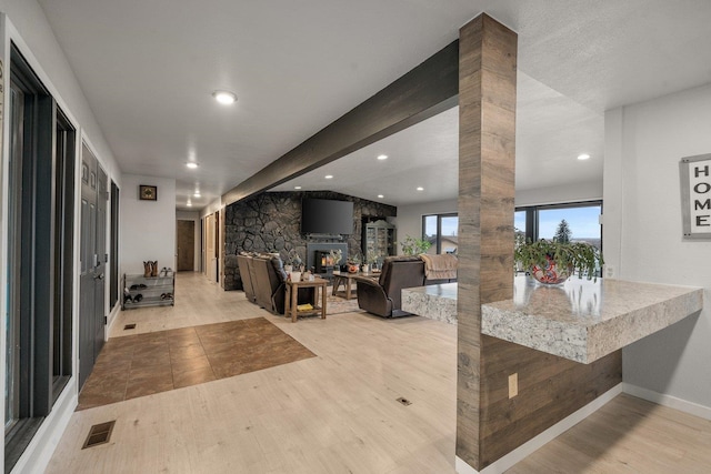 313 SE Trinity Ave, Wilbur, WA 99185 - living room featuring wood finished floors, a fireplace, recessed lighting, decorative columns, and baseboards