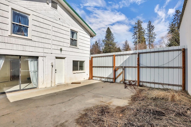 870 E 8th Ave, Colville, WA 99114 - view of side of property featuring a patio, concrete block siding, fence, and a gate