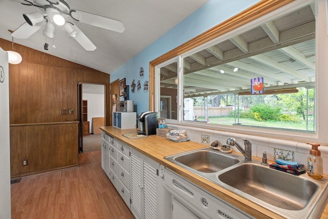 1804 S Blake Rd, Spokane Valley, WA 99216 - kitchen with light countertops, white cabinetry, a sink, light wood finished floors, and vaulted ceiling