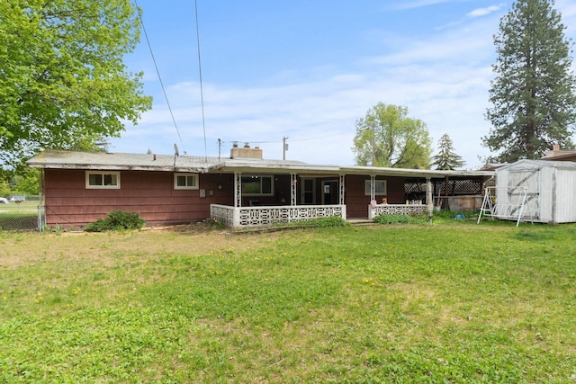 1804 S Blake Rd, Spokane Valley, WA 99216 - rear view of property with a yard, fence, an outbuilding, and a storage unit