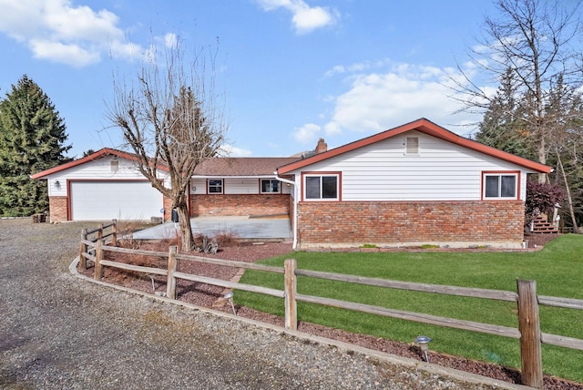 147 N Lindsey St, Tekoa, WA 99033 - ranch-style home with a front yard, a chimney, fence, brick siding, and gravel driveway