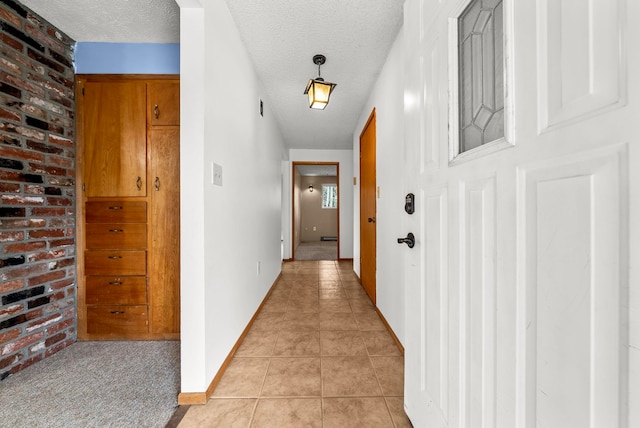 147 N Lindsey St, Tekoa, WA 99033 - hallway with baseboards, a textured ceiling, and light tile patterned floors