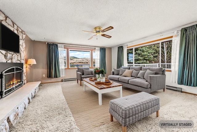 147 N Lindsey St, Tekoa, WA 99033 - living area featuring a textured ceiling, a fireplace, a baseboard heating unit, and a ceiling fan