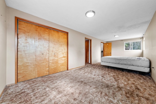 147 N Lindsey St, Tekoa, WA 99033 - unfurnished bedroom with baseboards, a closet, and carpet floors