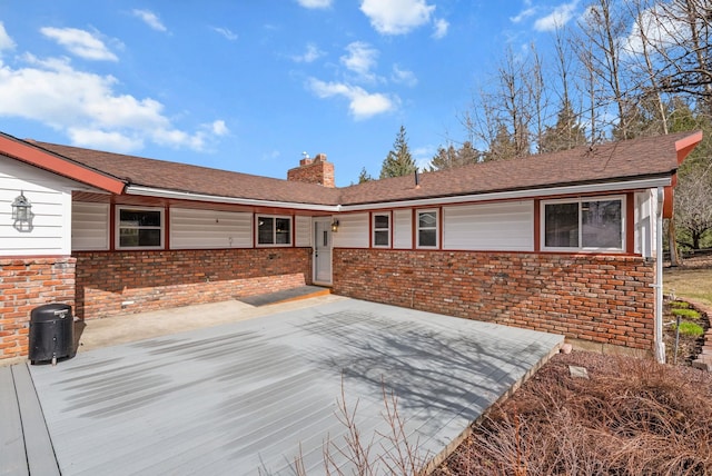 147 N Lindsey St, Tekoa, WA 99033 - view of front facade featuring brick siding and a chimney