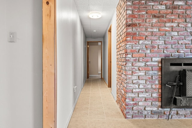 147 N Lindsey St, Tekoa, WA 99033 - hallway with a drop ceiling, tile patterned floors, and baseboards