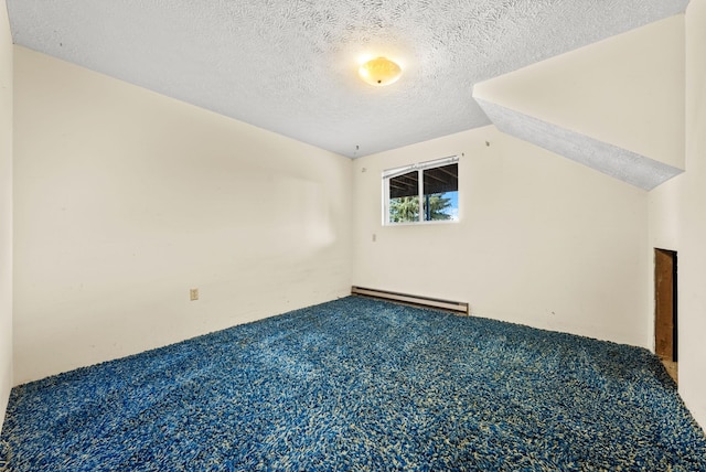 147 N Lindsey St, Tekoa, WA 99033 - carpeted spare room featuring vaulted ceiling, a baseboard heating unit, and a textured ceiling