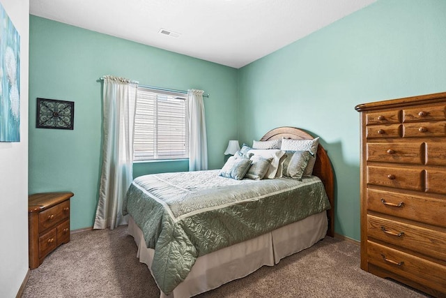 carpeted bedroom with baseboards and visible vents