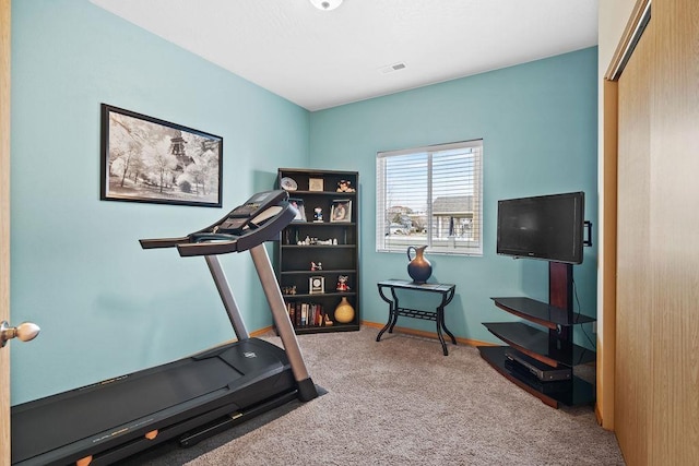 exercise room featuring visible vents, carpet, and baseboards
