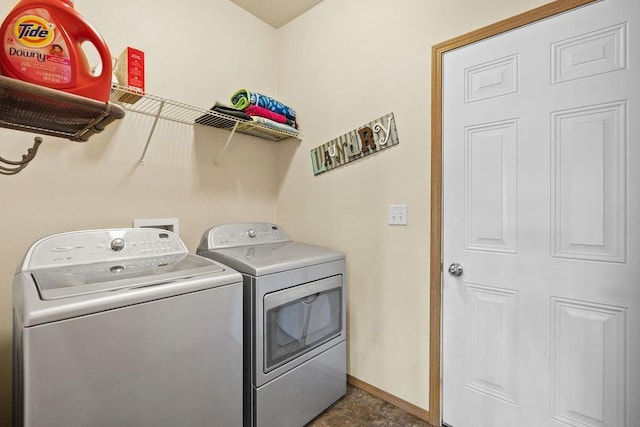 laundry room with baseboards, laundry area, and washer and clothes dryer