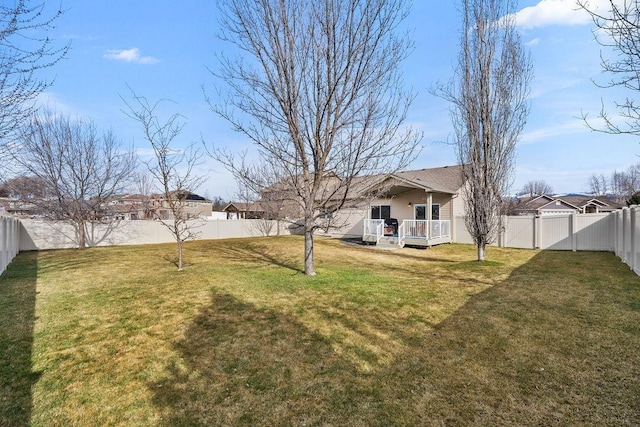 view of yard with a deck and a fenced backyard