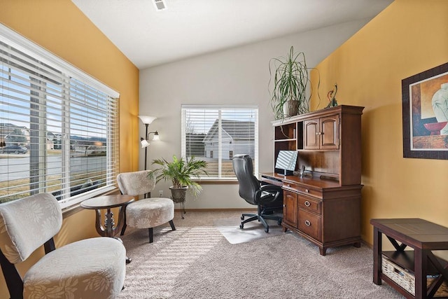 home office featuring baseboards, light colored carpet, and lofted ceiling
