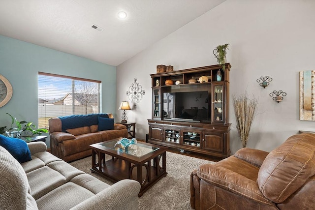 living area with visible vents and lofted ceiling
