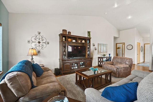 living room featuring high vaulted ceiling and wood finished floors
