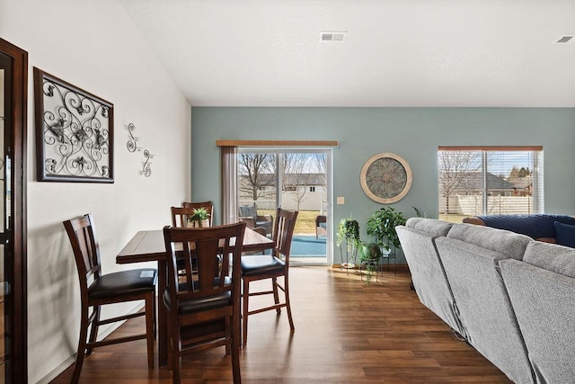 dining area with dark wood-style flooring and visible vents