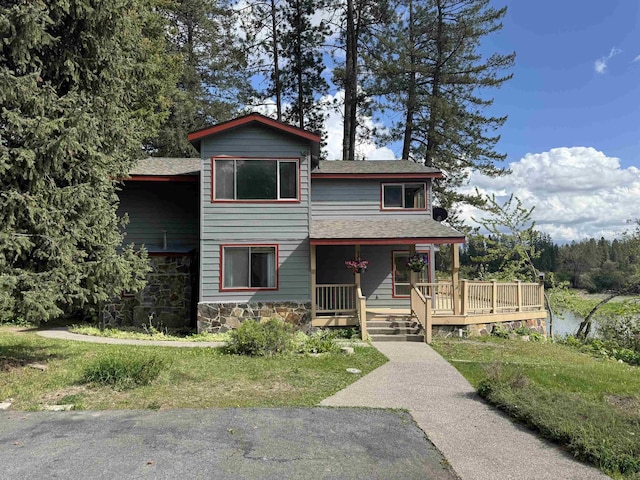 1791 S Leclerc Rd, Newport, WA 99156 - view of front of property with stone siding, covered porch, and roof with shingles