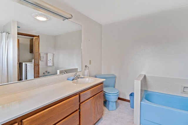 1791 S Leclerc Rd, Newport, WA 99156 - full bathroom featuring toilet, vanity, a bath, baseboards, and independent washer and dryer