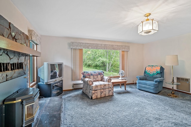 1791 S Leclerc Rd, Newport, WA 99156 - carpeted living area with baseboard heating, baseboards, and a wood stove