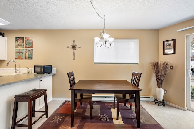 10321 E Main Ave Ste 104, Spokane, WA 99206 - carpeted dining area featuring baseboards, a textured ceiling, a sink, and a chandelier