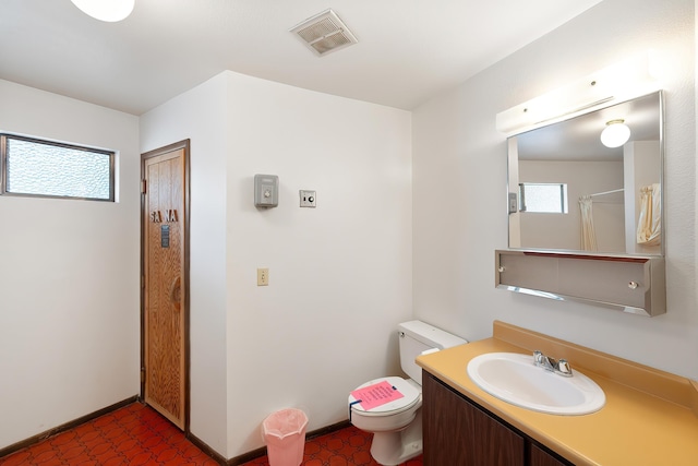 10321 E Main Ave Ste 104, Spokane, WA 99206 - bathroom with toilet, baseboards, a healthy amount of sunlight, and visible vents