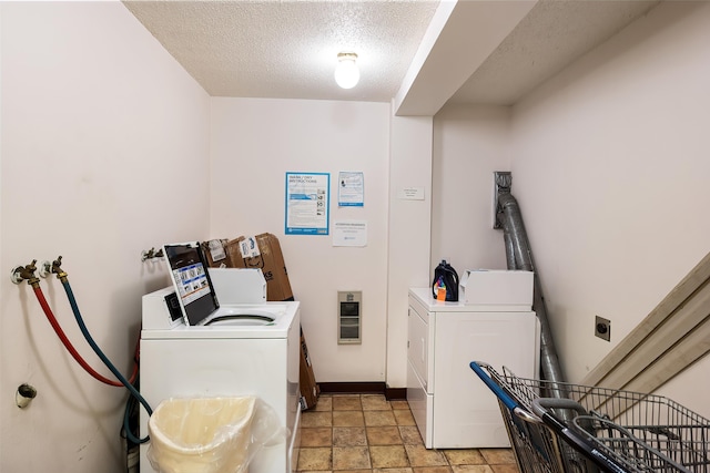 10321 E Main Ave Ste 104, Spokane, WA 99206 - community laundry room with baseboards, a textured ceiling, stone finish floor, and washer and dryer