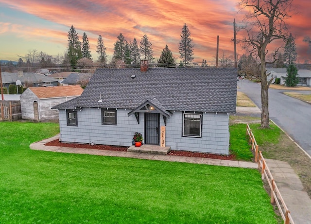 2337 W Kiernan Ave, Spokane, WA 99205 - view of front of house featuring fence, roof with shingles, and a front lawn