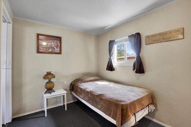 carpeted bedroom with baseboards and ornamental molding