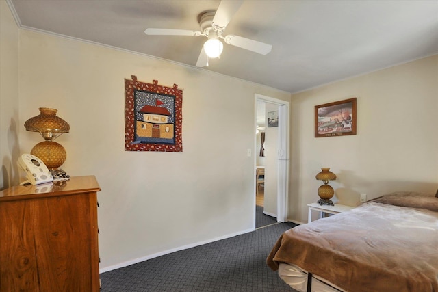 bedroom featuring baseboards, dark colored carpet, and crown molding