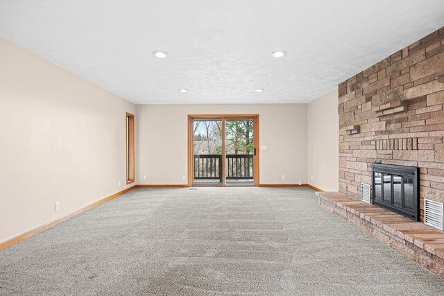 12115 E Wedgewood Ct, Spokane, WA 99217 - unfurnished living room featuring carpet floors, a fireplace, baseboards, recessed lighting, and a textured ceiling