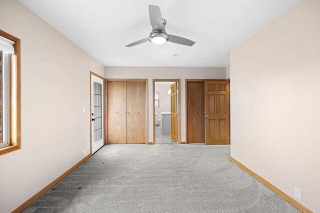 12115 E Wedgewood Ct, Spokane, WA 99217 - unfurnished bedroom with baseboards, light carpet, ensuite bath, and a ceiling fan