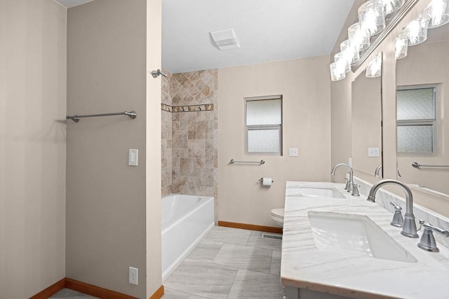 12115 E Wedgewood Ct, Spokane, WA 99217 - bathroom with baseboards, toilet, double vanity, and washtub / shower combination