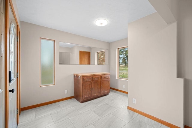12115 E Wedgewood Ct, Spokane, WA 99217 - kitchen featuring baseboards, brown cabinetry, and light countertops