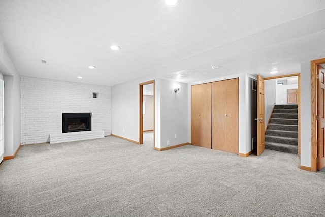 12115 E Wedgewood Ct, Spokane, WA 99217 - unfurnished living room featuring carpet floors, baseboards, stairway, a fireplace, and recessed lighting