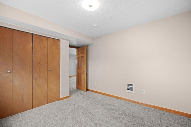 12115 E Wedgewood Ct, Spokane, WA 99217 - unfurnished bedroom featuring carpet flooring, baseboards, a closet, a textured ceiling, and heating unit