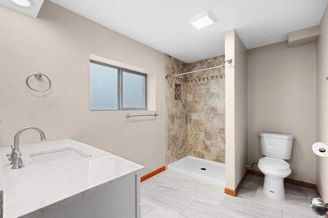 12115 E Wedgewood Ct, Spokane, WA 99217 - bathroom with baseboards, toilet, a tile shower, and vanity