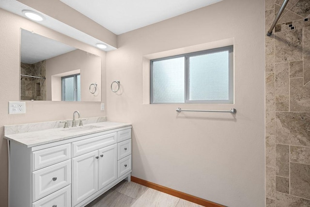 12115 E Wedgewood Ct, Spokane, WA 99217 - full bath featuring vanity, tiled shower, and baseboards
