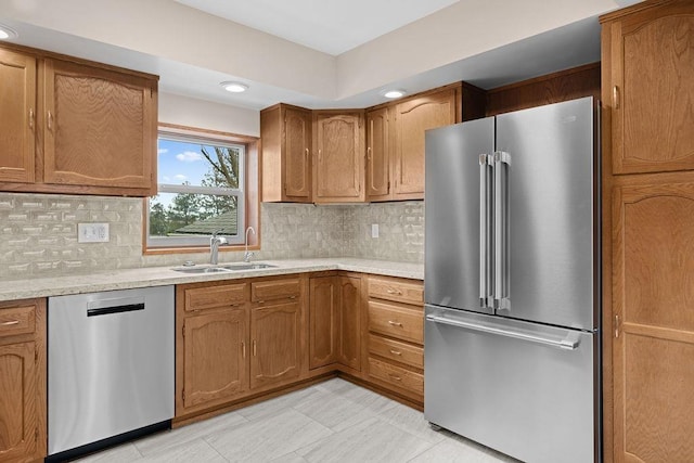 12115 E Wedgewood Ct, Spokane, WA 99217 - kitchen with appliances with stainless steel finishes, a sink, brown cabinets, tasteful backsplash, and recessed lighting