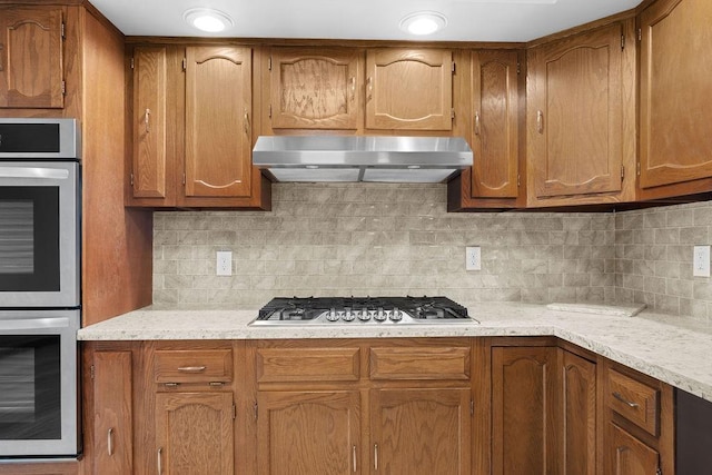 12115 E Wedgewood Ct, Spokane, WA 99217 - kitchen featuring extractor fan, appliances with stainless steel finishes, and brown cabinetry