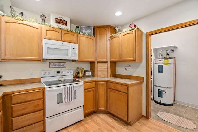 146 Laurelhurst Dr Unit 146, Newport, WA 99156 - kitchen featuring light wood finished floors, water heater, white appliances, light countertops, and recessed lighting