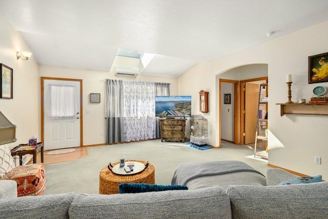 146 Laurelhurst Dr Unit 146, Newport, WA 99156 - carpeted living area with a skylight, a wall mounted AC, arched walkways, and baseboards