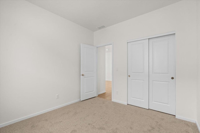 unfurnished bedroom with baseboards, visible vents, and carpet floors