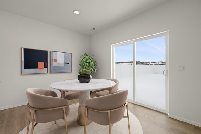 dining area with baseboards, visible vents, recessed lighting, and light wood finished floors