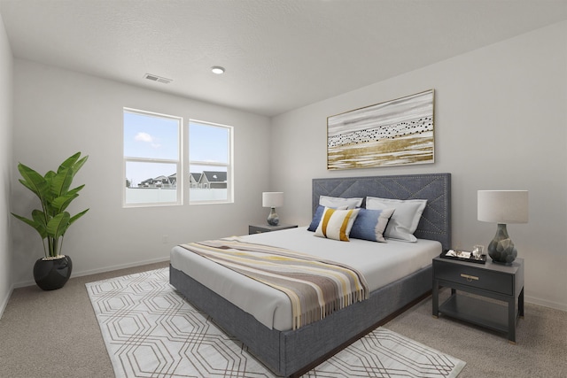 carpeted bedroom featuring baseboards and visible vents