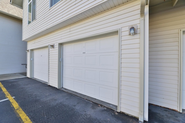 garage featuring aphalt driveway